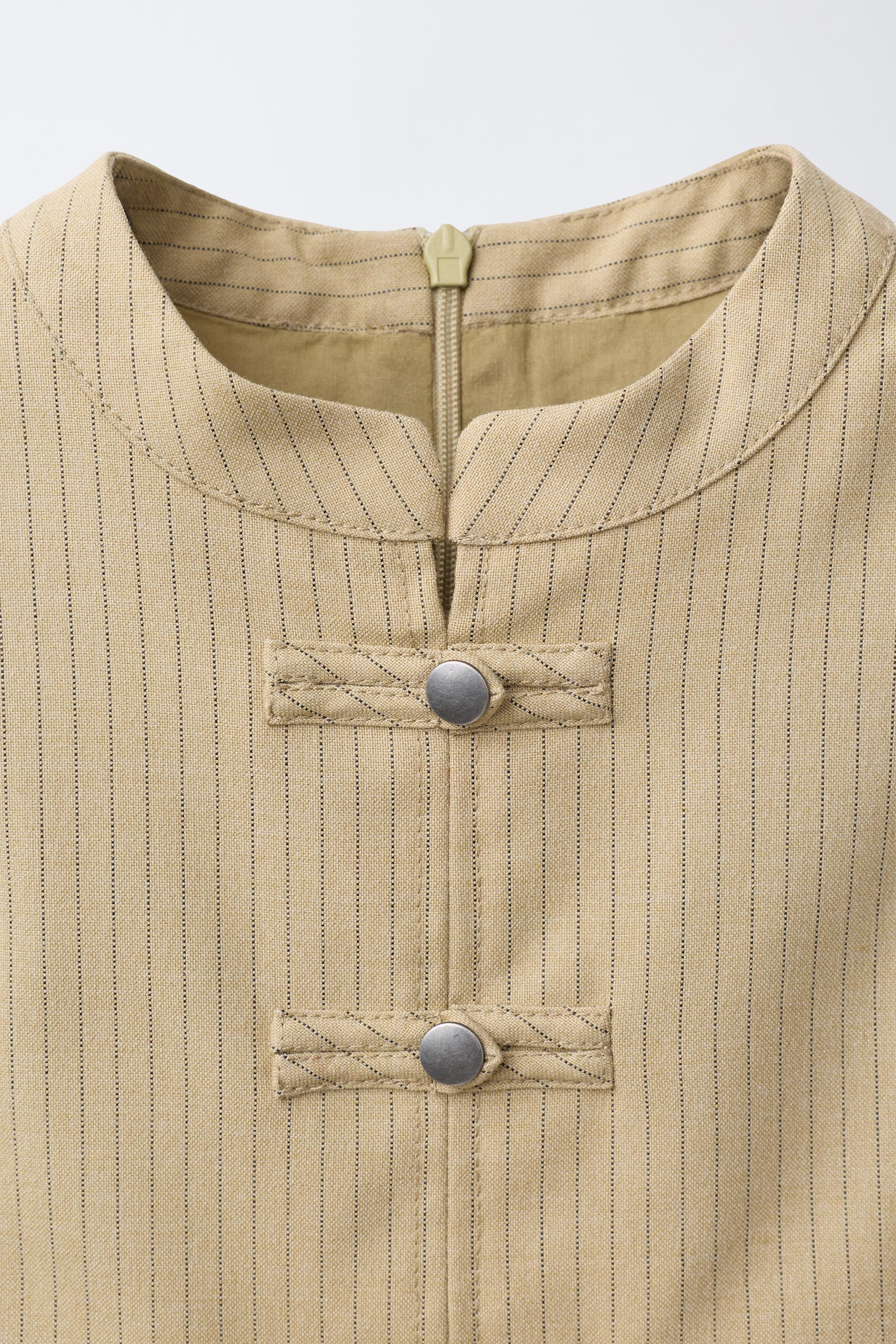 STRIPED DRESS WITH FROG FASTENINGS